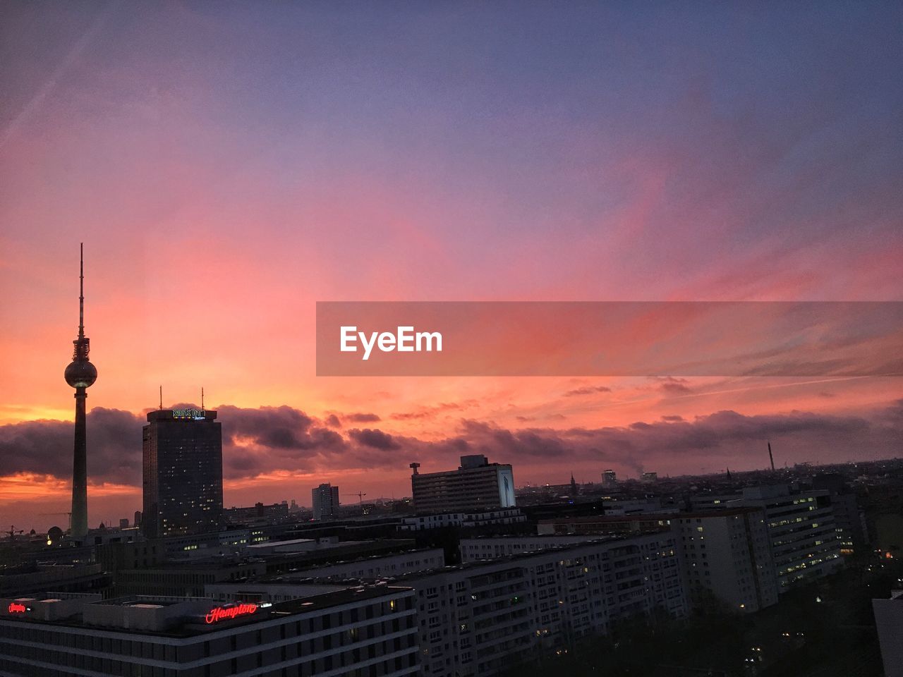 Silhouette fernsehturm against sky during sunset
