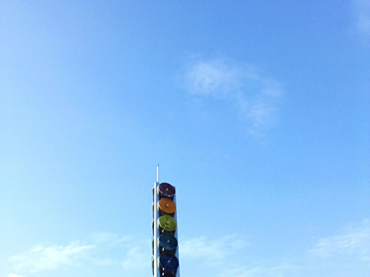 HIGH SECTION OF TOWER AGAINST BLUE SKY