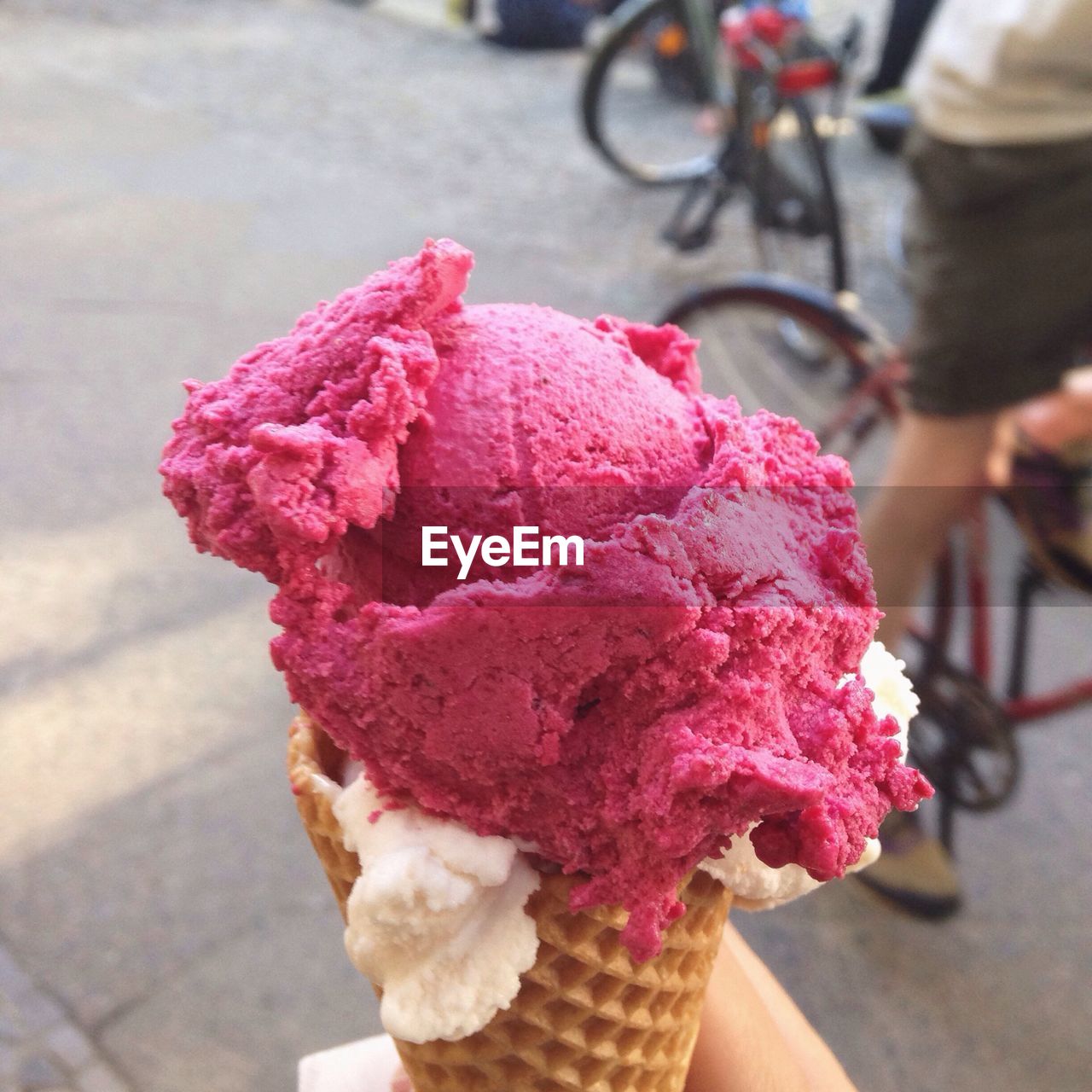 Close-up of hand holding ice cream cone outdoors