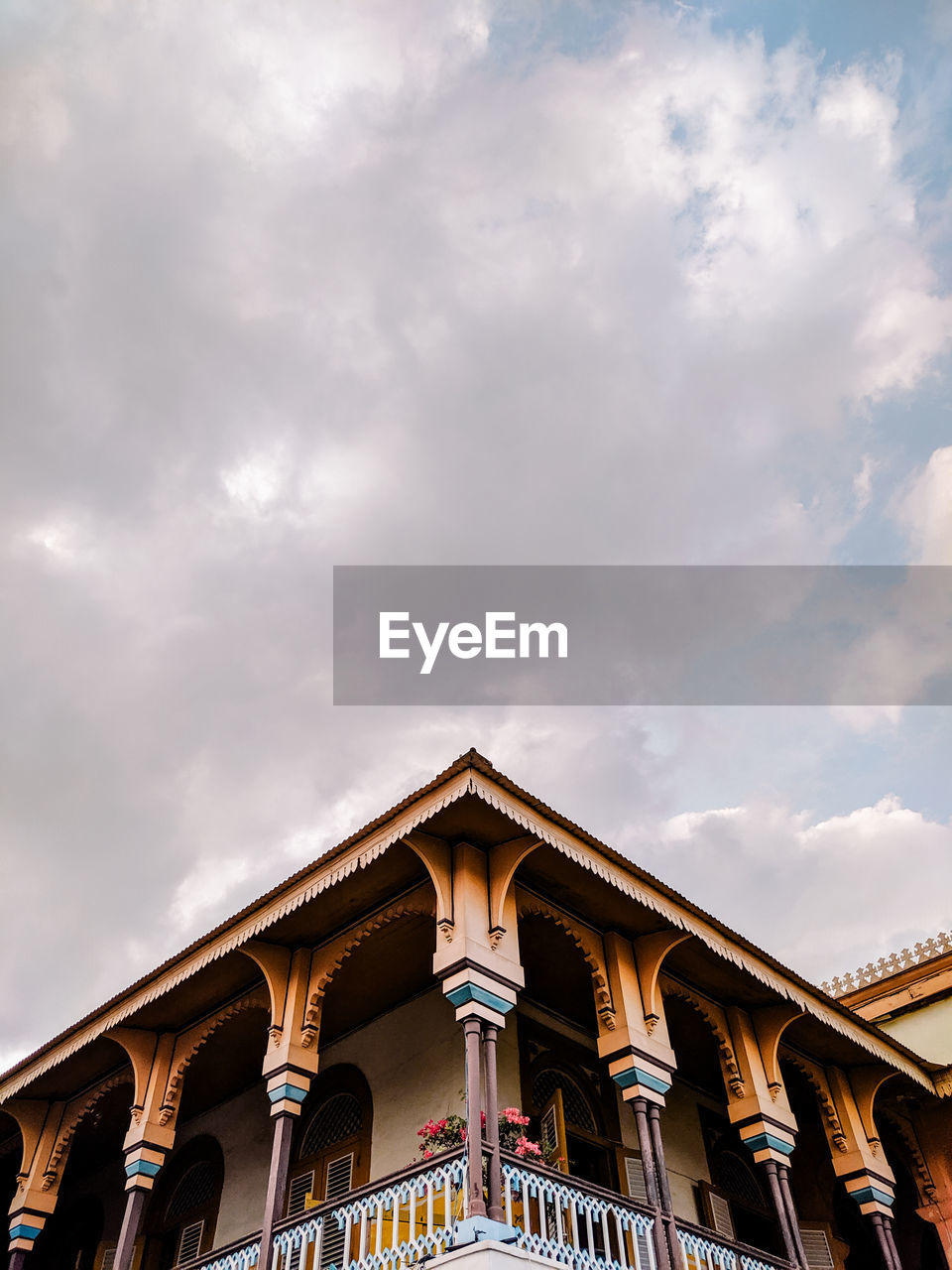 Low angle view of building against cloudy sky