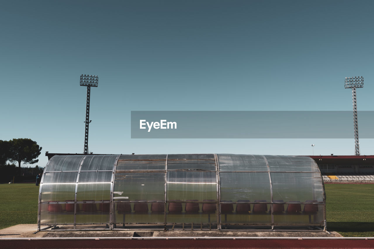 LOW ANGLE VIEW OF FLOODLIGHT AGAINST SKY