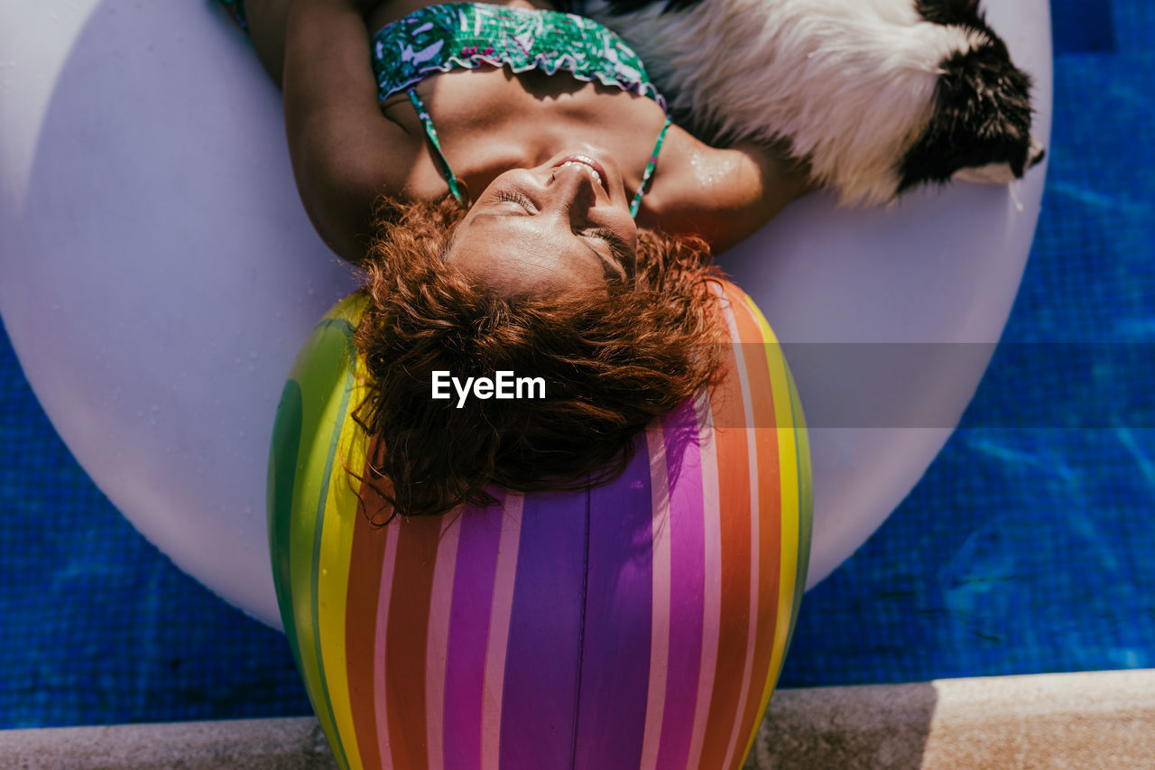 Midsection of women sitting in swimming pool