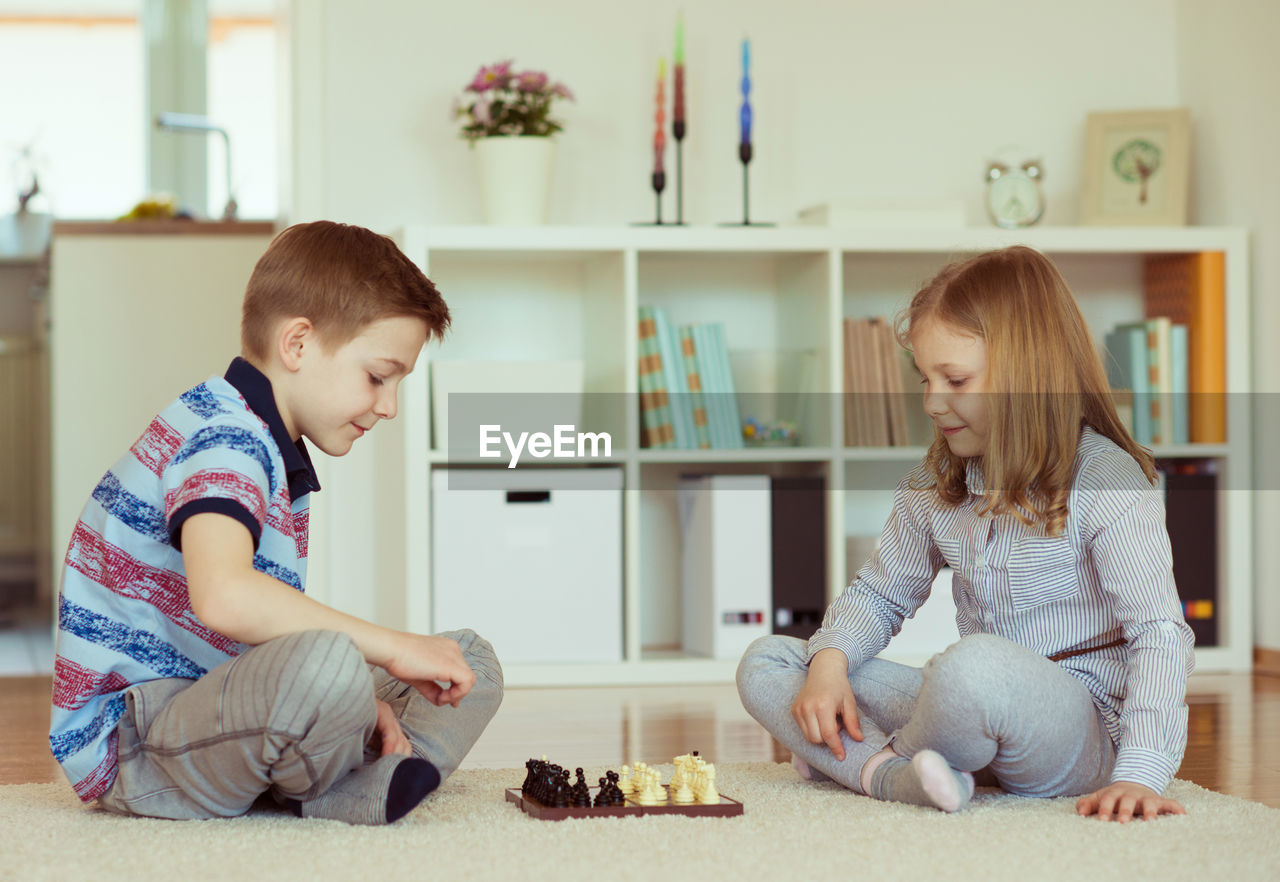 Siblings sitting at home