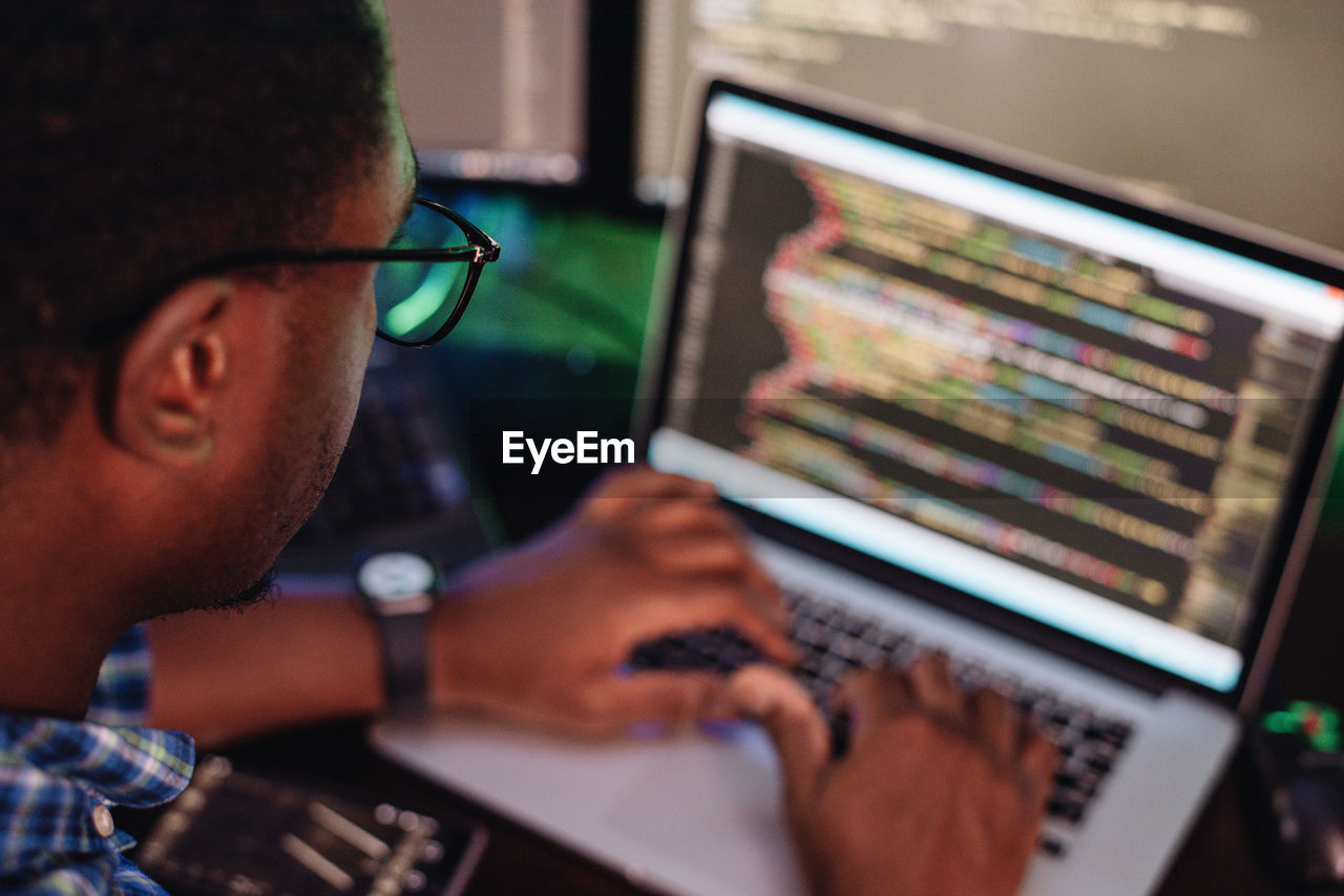 Close-up of computer programmer working at office