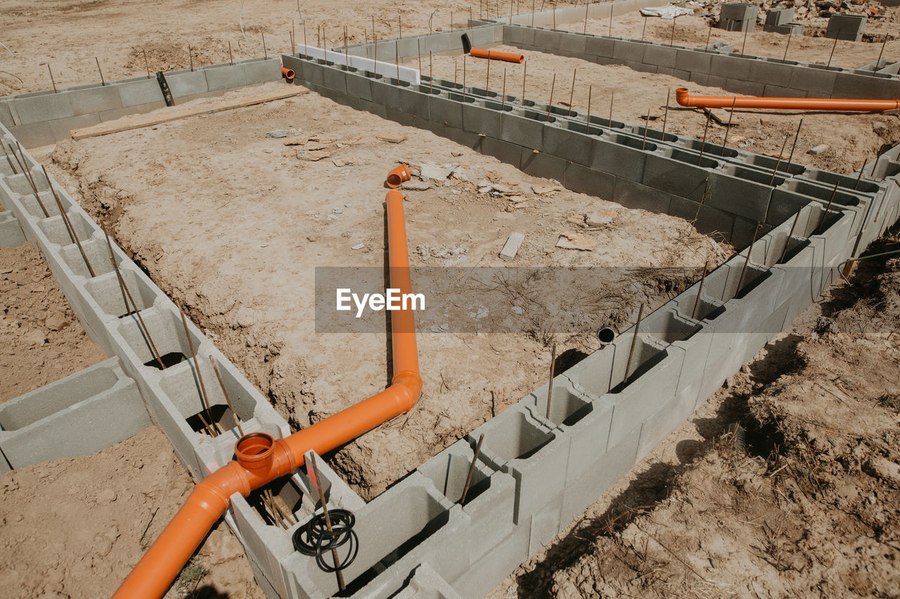 construction, foundation, high angle view, industry, construction site, construction industry, wall, day, no people, development, road construction, nature, outdoors, architecture, sunlight, track, land, soil