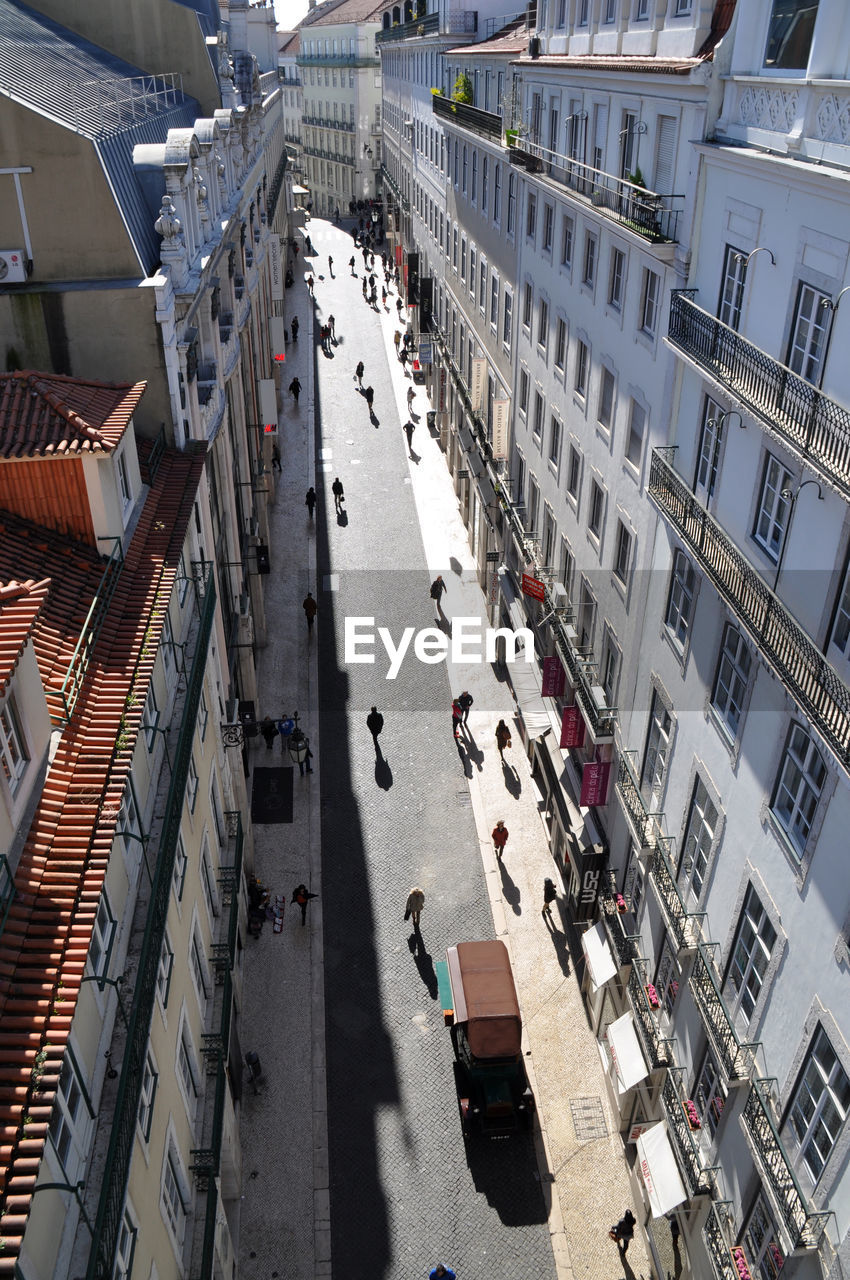 High angle view of people on road amidst buildings in city