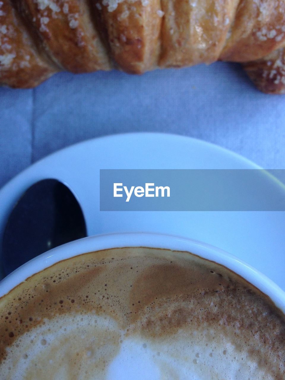 Directly above shot of cappuccino and croissant