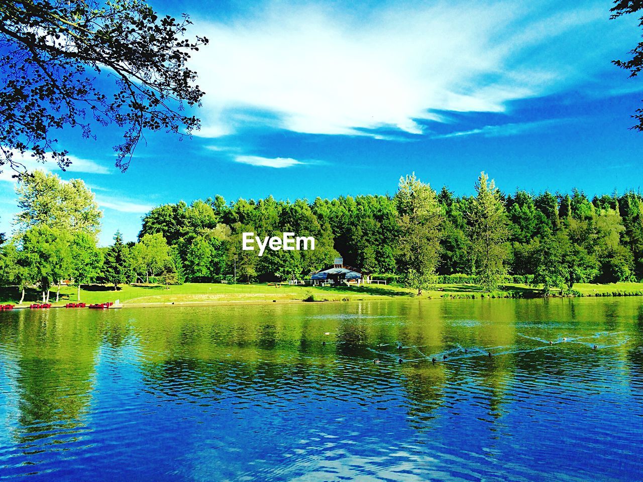 SCENIC VIEW OF CALM LAKE AGAINST CLOUDY SKY