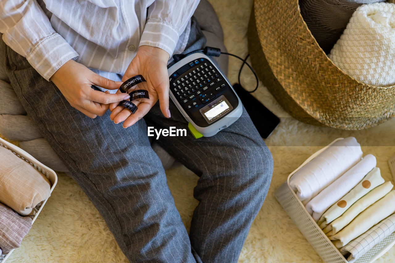 Midsection of woman using calculator