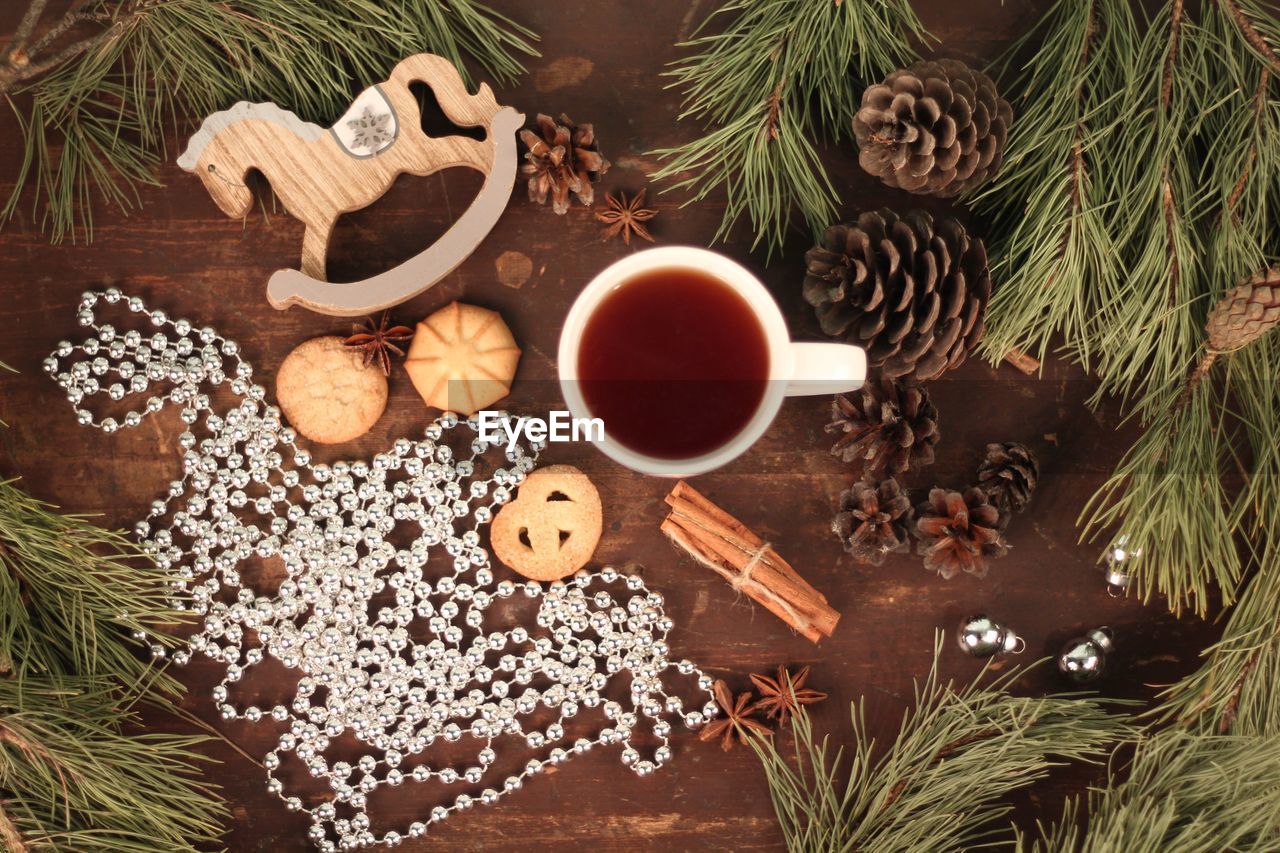 High angle view of coffee with cookies and christmas decorations on table