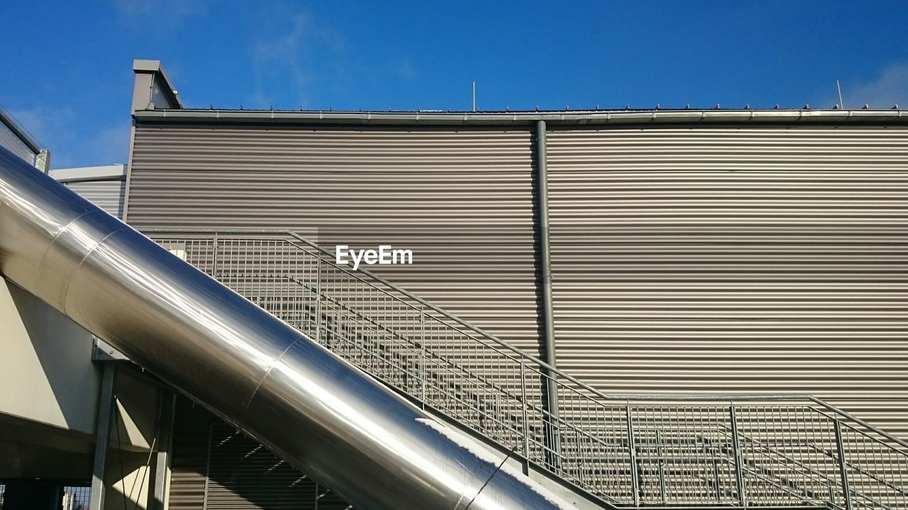 Buildings against clear blue sky