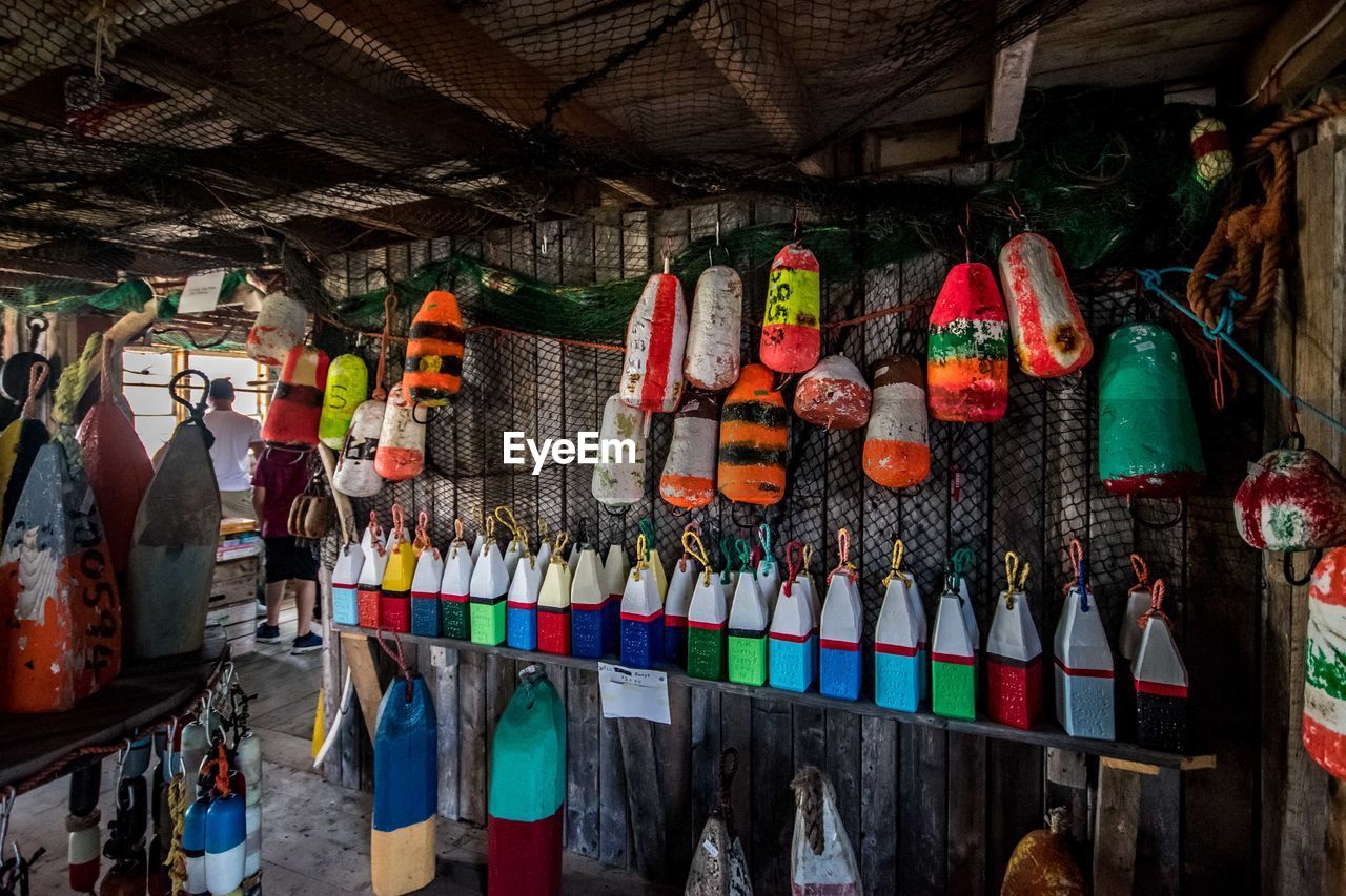 Multi colored hanging buoys for sale in fish market.