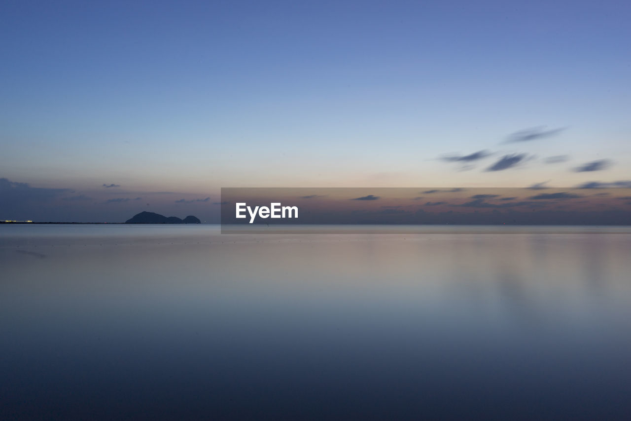 Scenic view of sea against sky at sunset