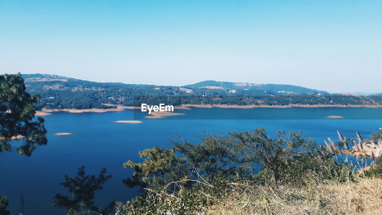 Scenic view of sea against clear blue sky