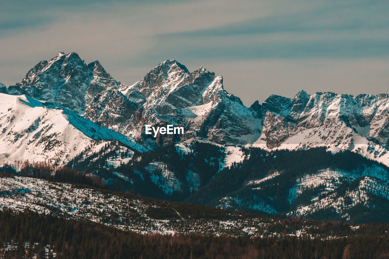 Panoramic view of snowcapped mountains against sky