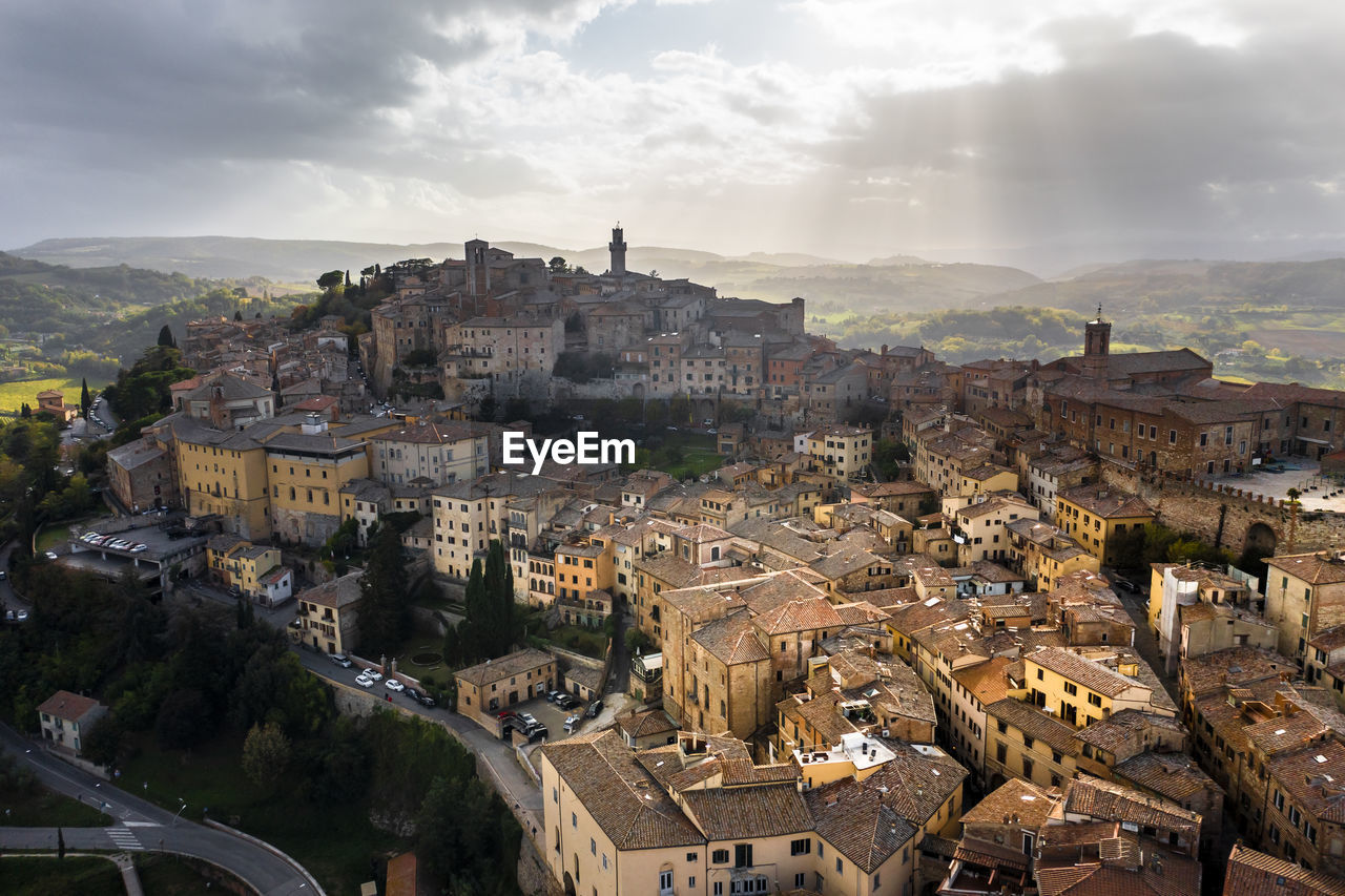 Italy, province of siena, montepulciano, helicopter view of medieval hill town in val dorcia at cloudy day