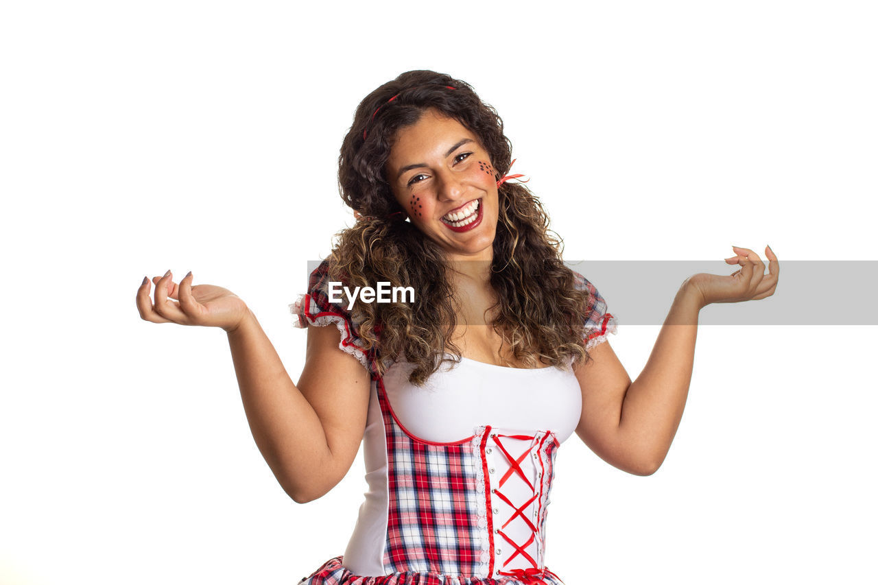 SMILING YOUNG WOMAN AGAINST WHITE BACKGROUND