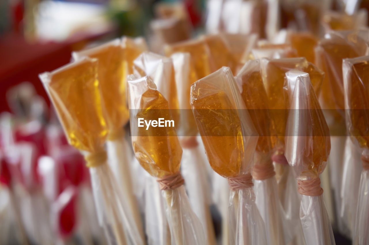 Close-up of candies wrapped in plastic for sale at market stall