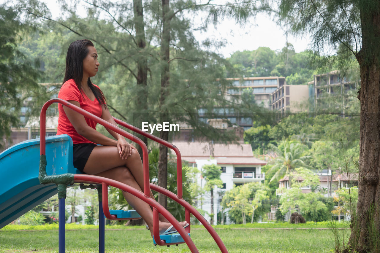 WOMAN SITTING IN PARK