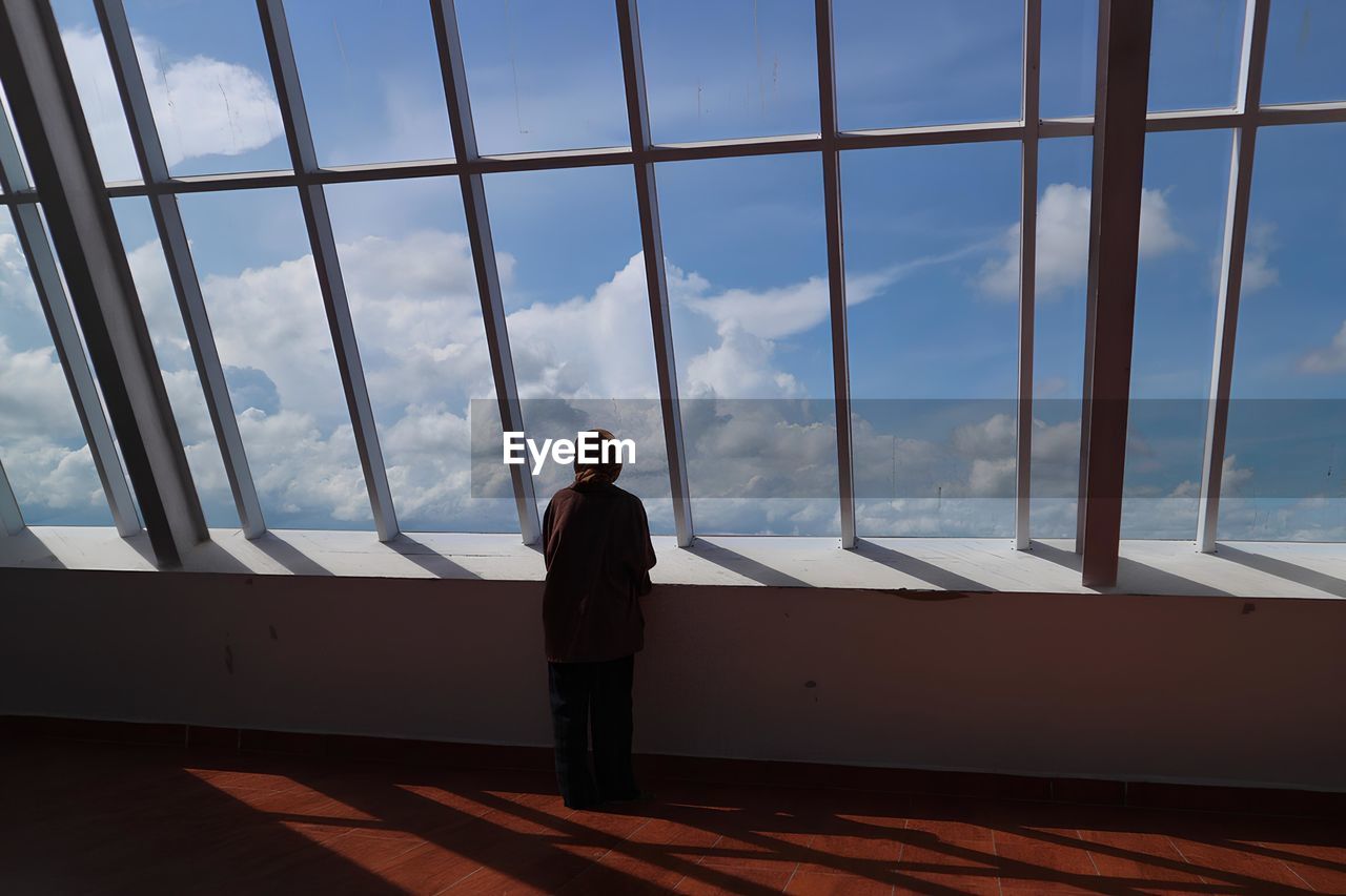 low angle view of man standing in front of building