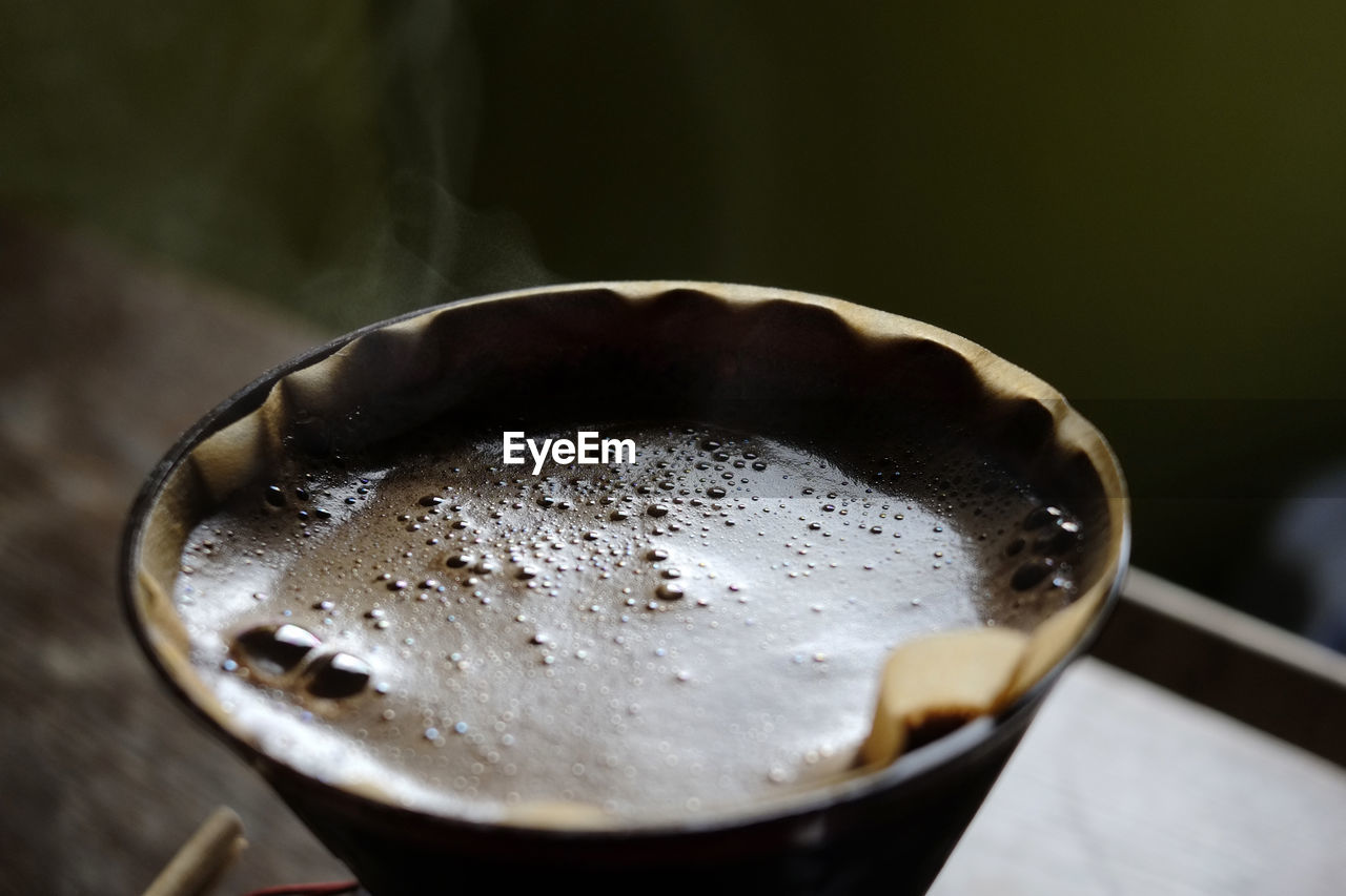 Close-up of coffee being filtered in cup