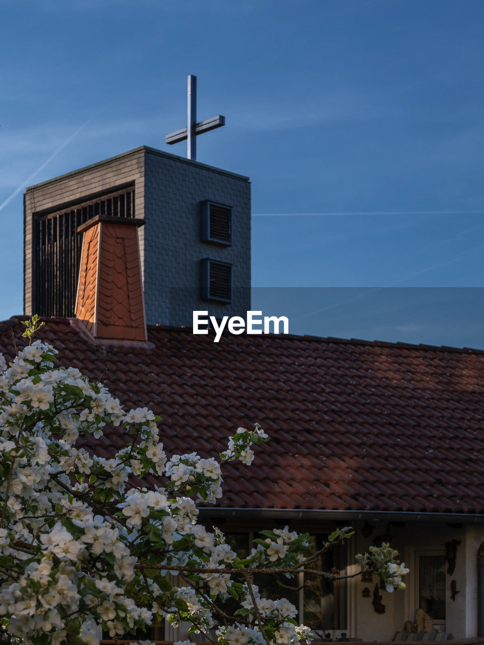 architecture, building exterior, built structure, building, sky, house, nature, no people, plant, flower, roof, low angle view, blue, day, outdoors, city, facade, place of worship, cloud, residential district