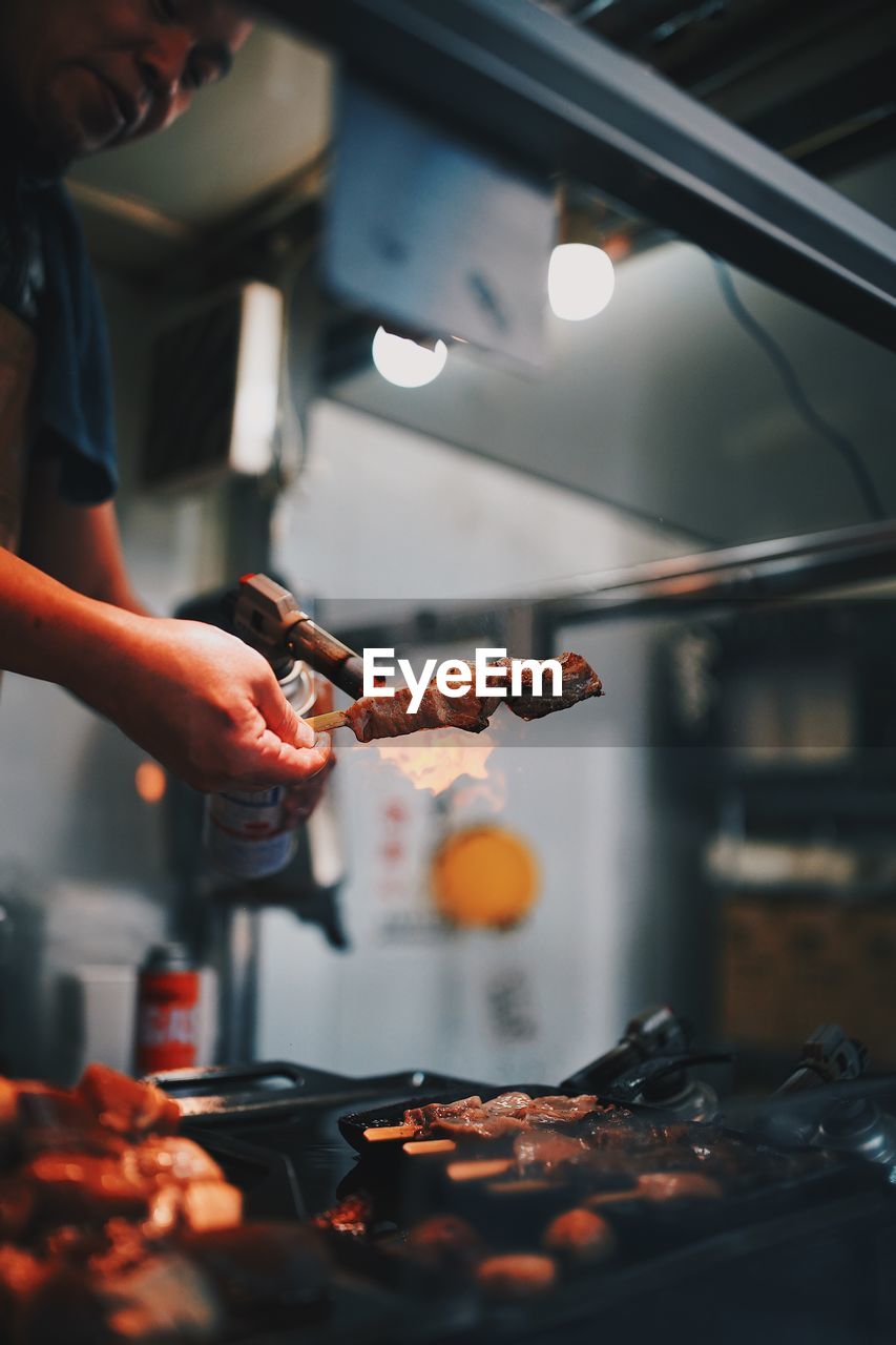 MIDSECTION OF MAN PREPARING FOOD