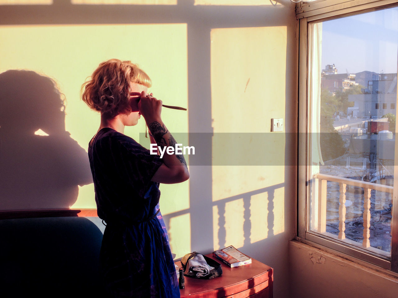 Woman standing by window