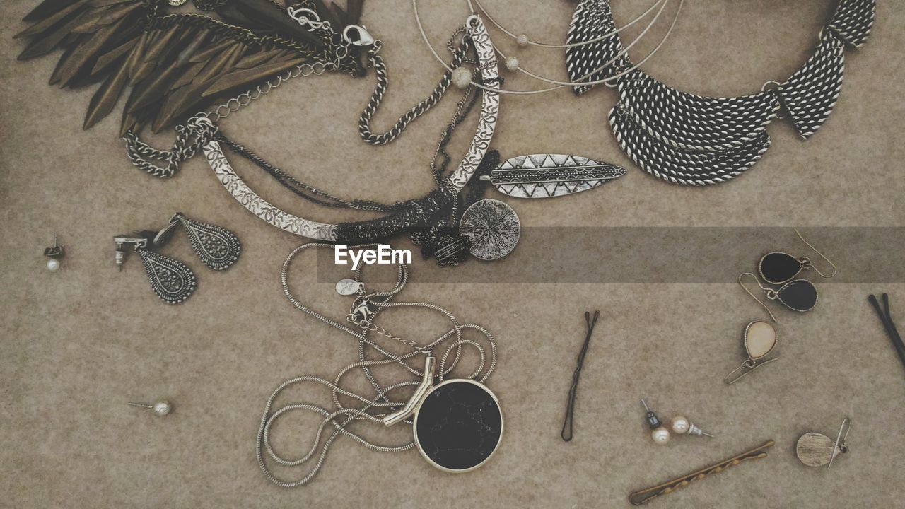 High angle view of various jewelry on table