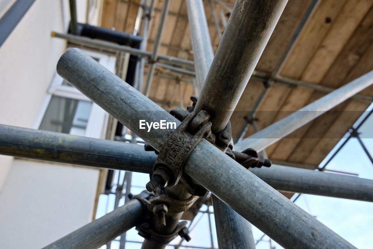 LOW ANGLE VIEW OF RUSTY METAL RAILING