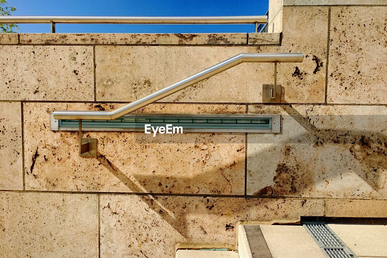 Close-up of steel bannister on dirty wall