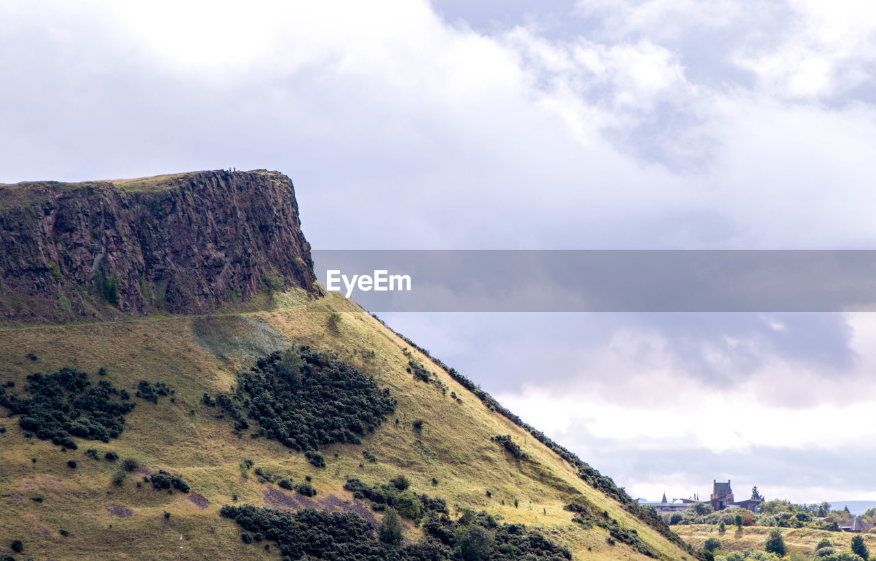 ROCK FORMATIONS ON MOUNTAIN AGAINST SKY