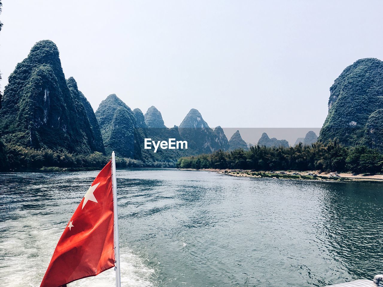 SCENIC VIEW OF RED AND MOUNTAIN AGAINST CLEAR SKY