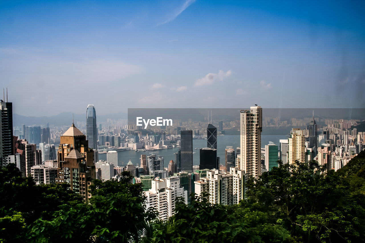 Modern buildings and victoria harbor against sky