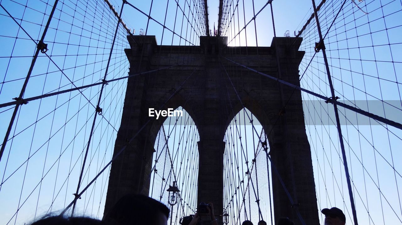 LOW ANGLE VIEW OF SUSPENSION BRIDGE CABLES