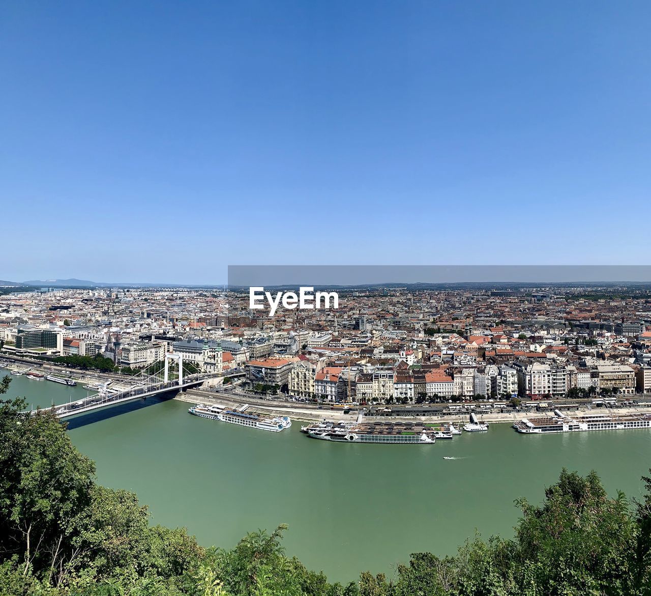 High angle view of city against blue sky