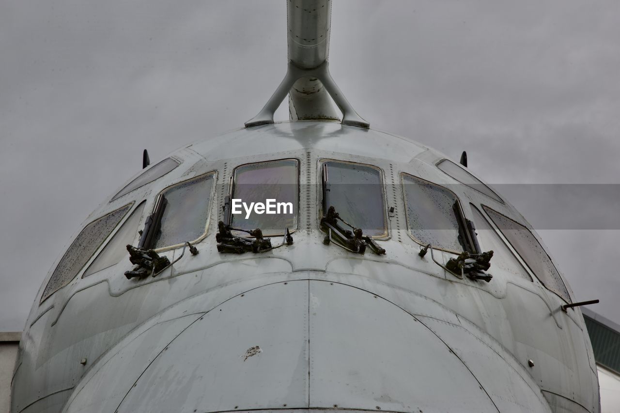 Low angle view of old airplane against sky