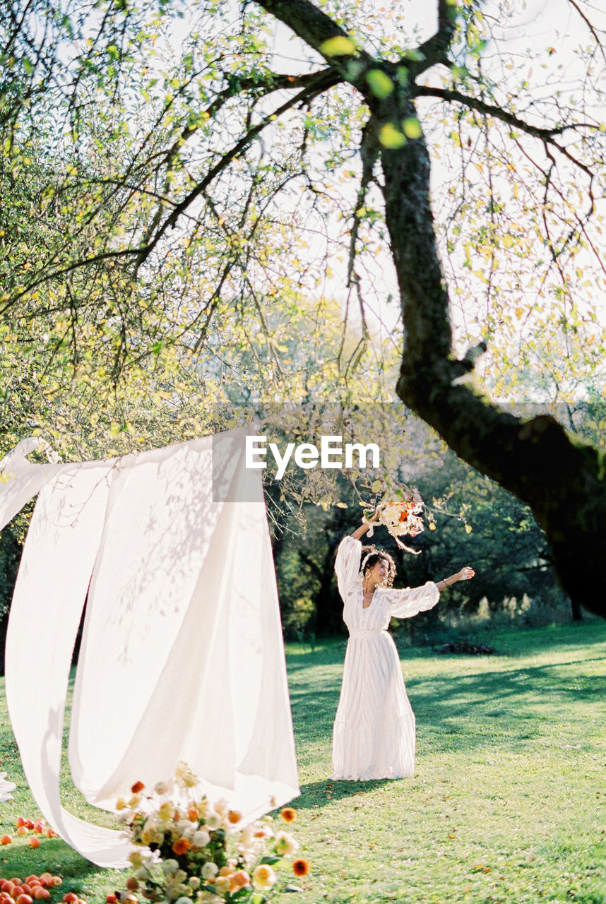 Rear view of bride standing in park