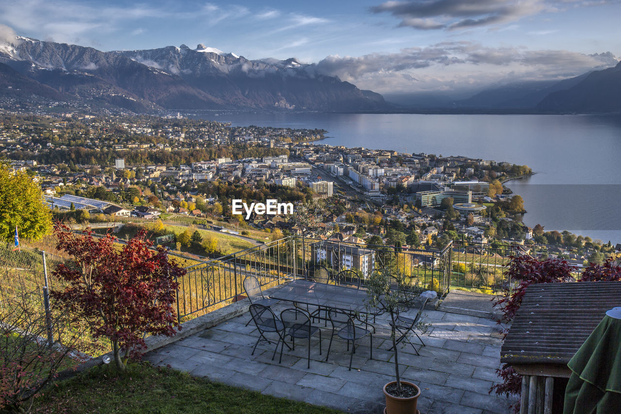 High angle view of townscape by mountains against sky