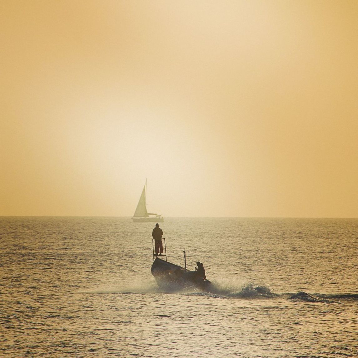 BOAT IN SEA AGAINST SKY