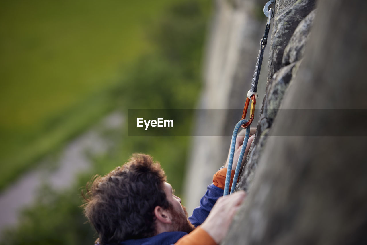 Close-up of man rock climbing