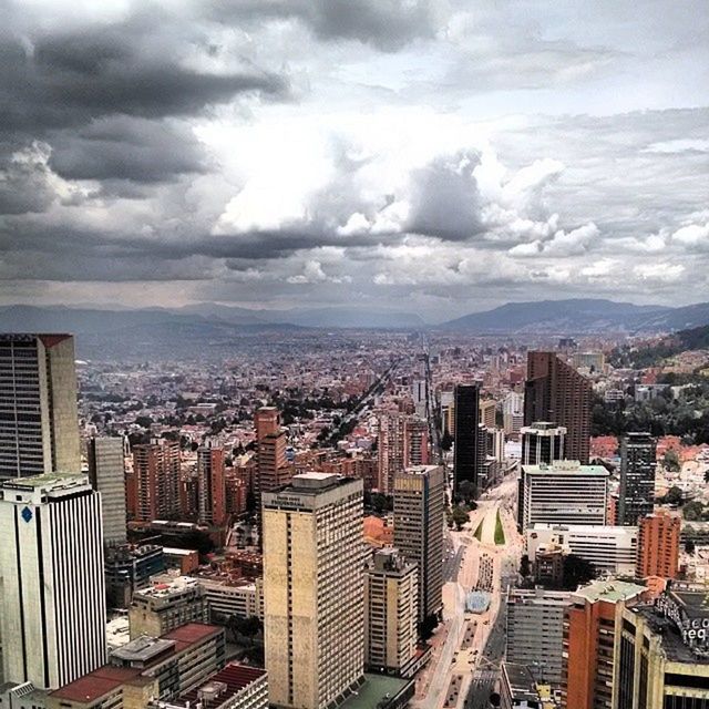 VIEW OF CITYSCAPE AGAINST CLOUDY SKY