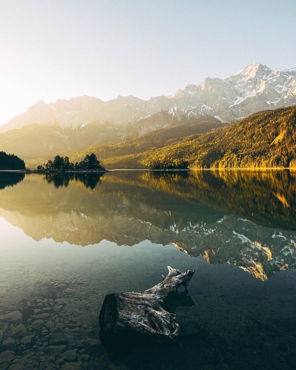 Scenic view of lake by mountains against clear sky