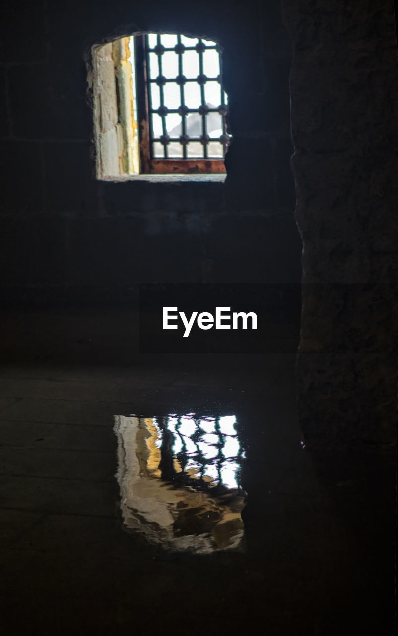 CLOSE-UP OF WINDOW IN ABANDONED ROOM