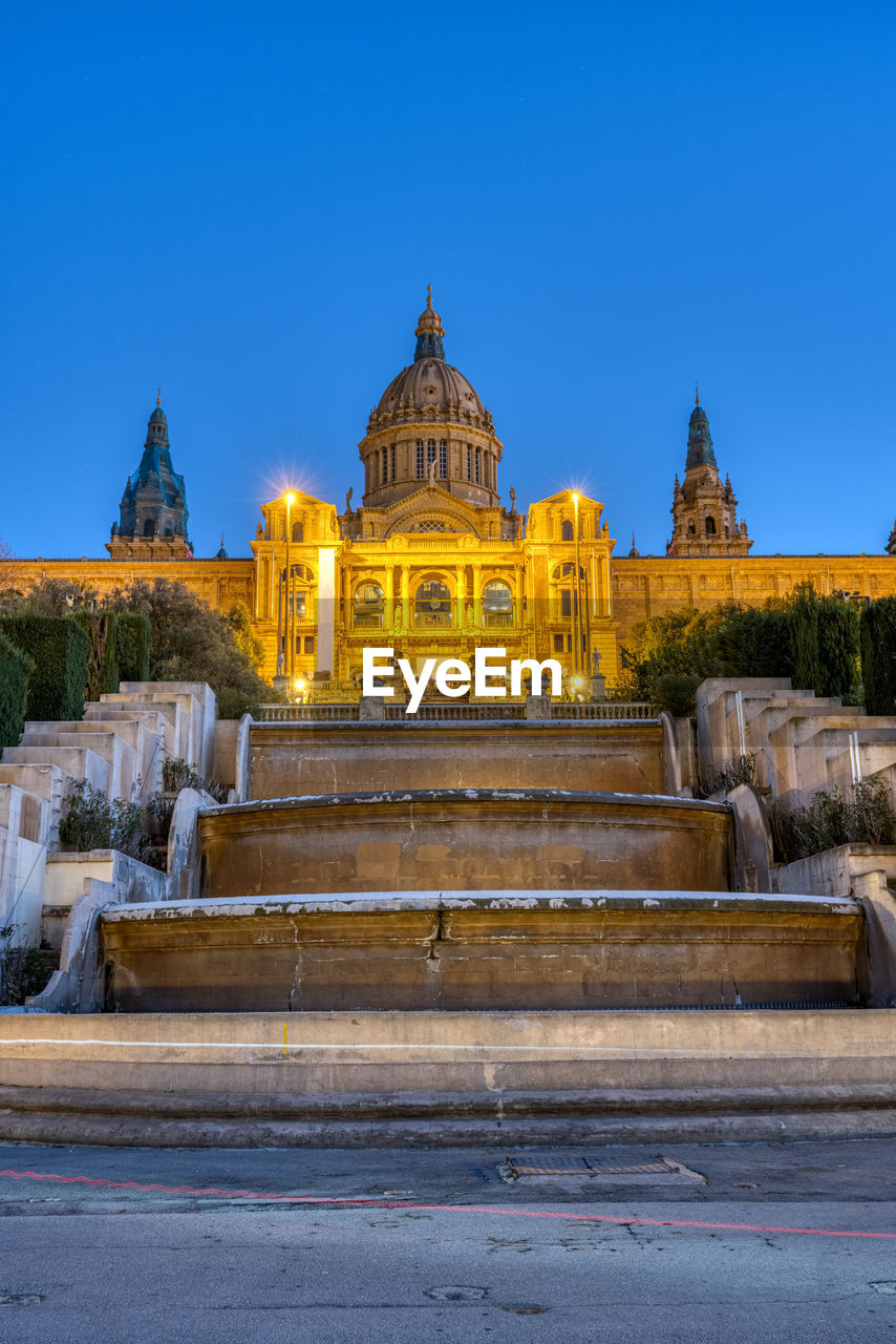 The national palace on montjuic mountain in barcelona illuminated at twilight