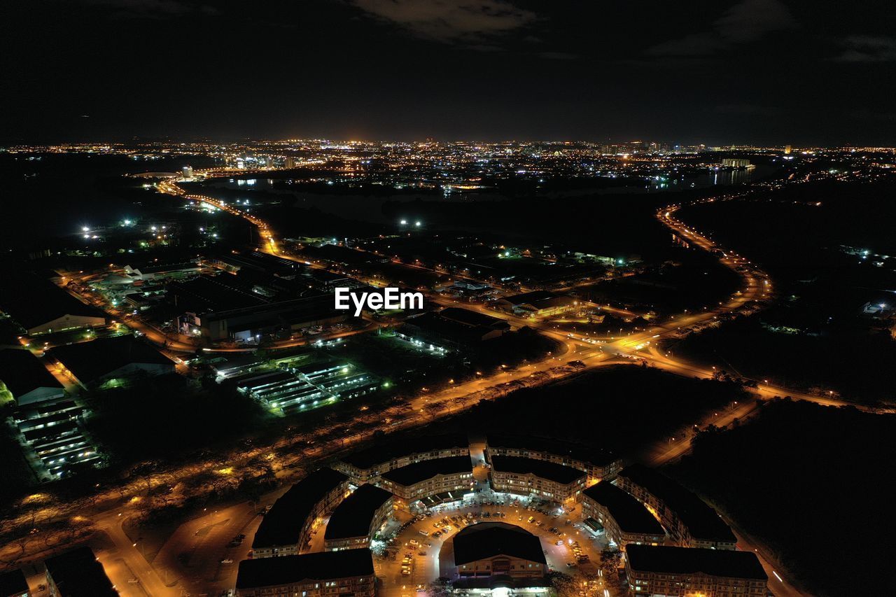 High angle view of illuminated buildings in city at night