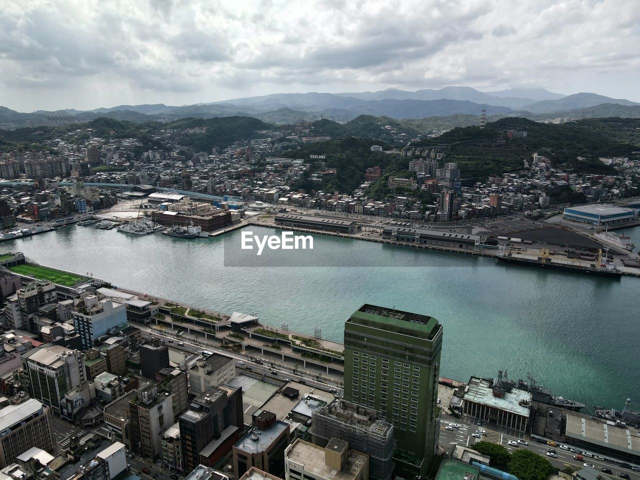 high angle view of townscape by lake against sky