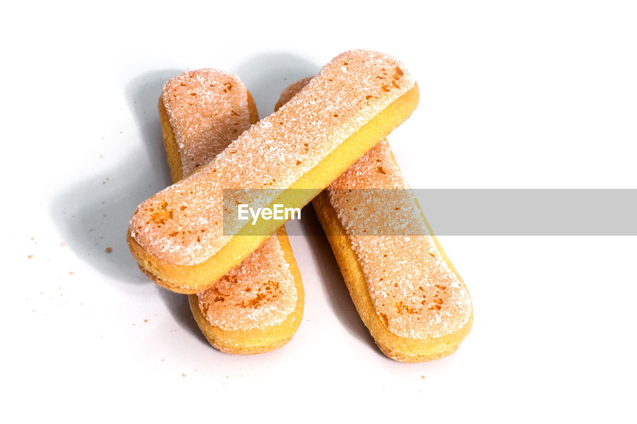 CLOSE-UP OF BREAD OVER WHITE BACKGROUND