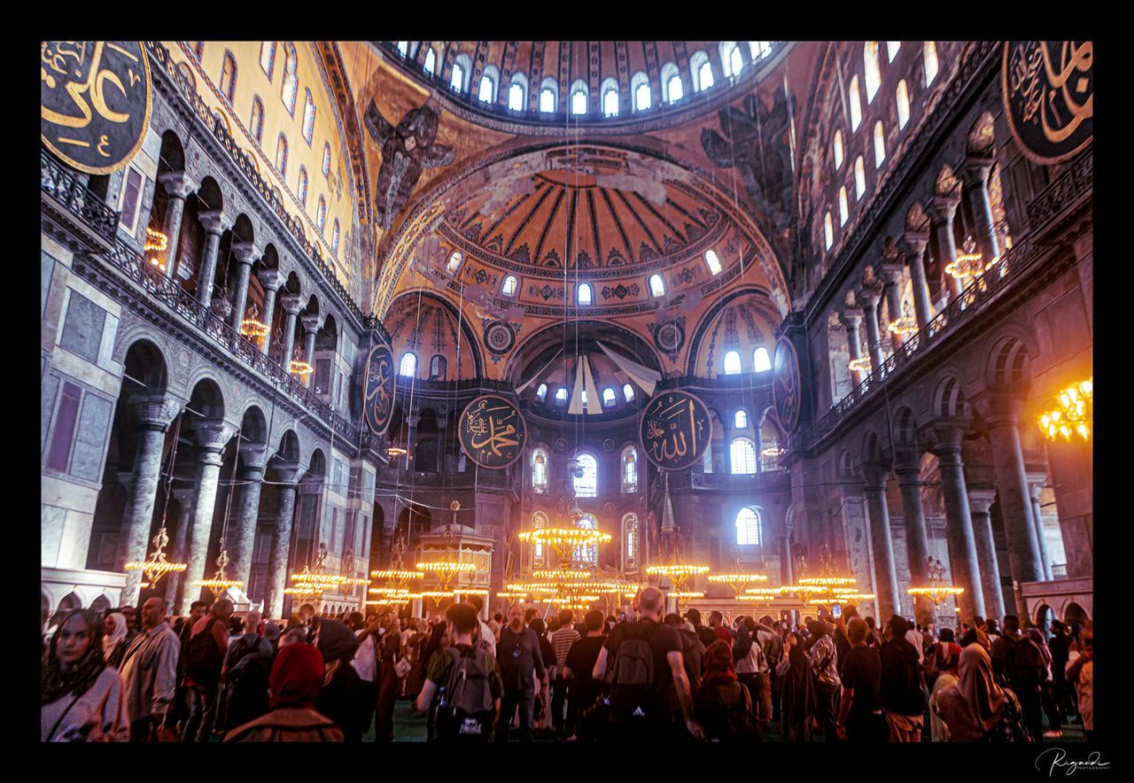 group of people, crowd, large group of people, architecture, built structure, illuminated, indoors, religion, place of worship, arts culture and entertainment, belief, transfer print, lighting equipment, event, building, stage, concert, spirituality, women, men, music, auto post production filter, travel destinations, night, adult