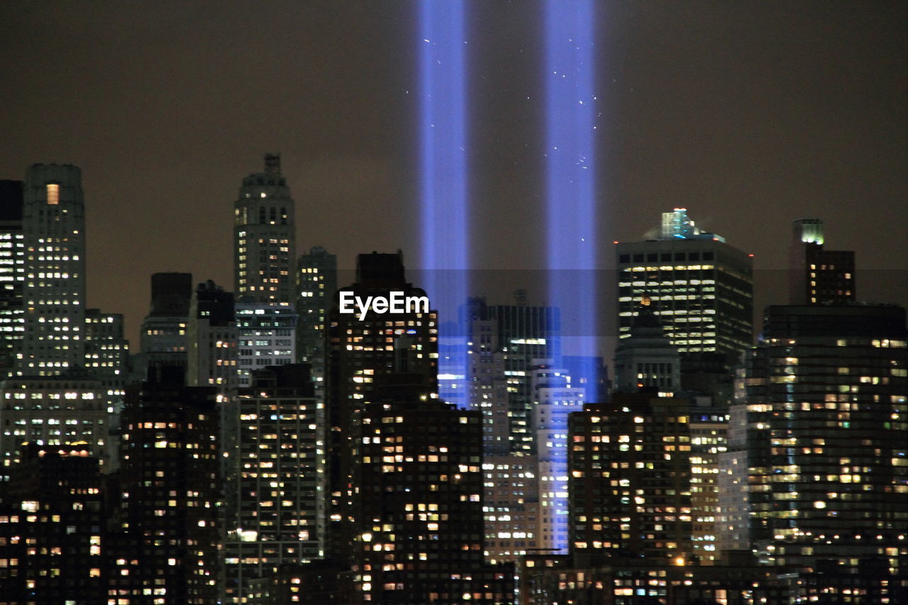 Digital composite image of illuminated cityscape at night